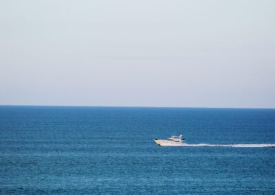 white and black boat on sea during daytime